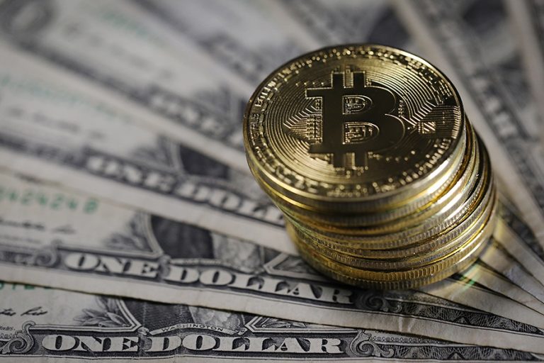 LONDON, ENGLAND - DECEMBER 07: A visual representation of the digital Cryptocurrency, Bitcoin alongside US Dollars on December 07, 2017 in London, England. Cryptocurrencies including Bitcoin, Ethereum, and Lightcoin have seen unprecedented growth in 2017, despite remaining extremely volatile. While digital currencies across the board have divided opinion between financial institutions, and now have a market cap of around 175 Billion USD, the crypto sector coninues to grow, as it continues to see wider mainstreem adoption. The price of one Bitcoin passed 15,000 USD across many exchanges today taking it higher than previous all time highs. (Photo by Dan Kitwood/Getty Images)