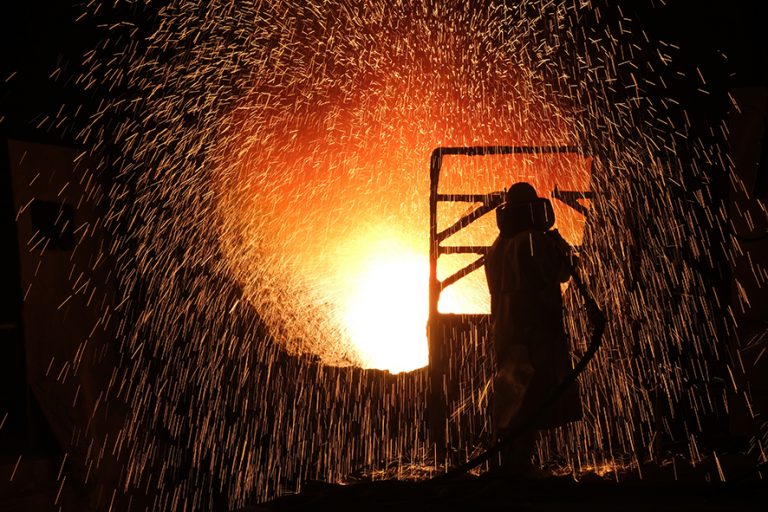 SALZGITTER, GERMANY - MARCH 05: Sparks fly as a worker in a heat resistant suit cleans the inside of a ladle used for transporting molten metal at the Salzgitter AG steelworks on March 05, 2019 in Salzgitter, Germany. Salzgitter produces a wide variety of steel products, including galvanized flat steel used for cars and appliances. (Photo by Sean Gallup/Getty Images)