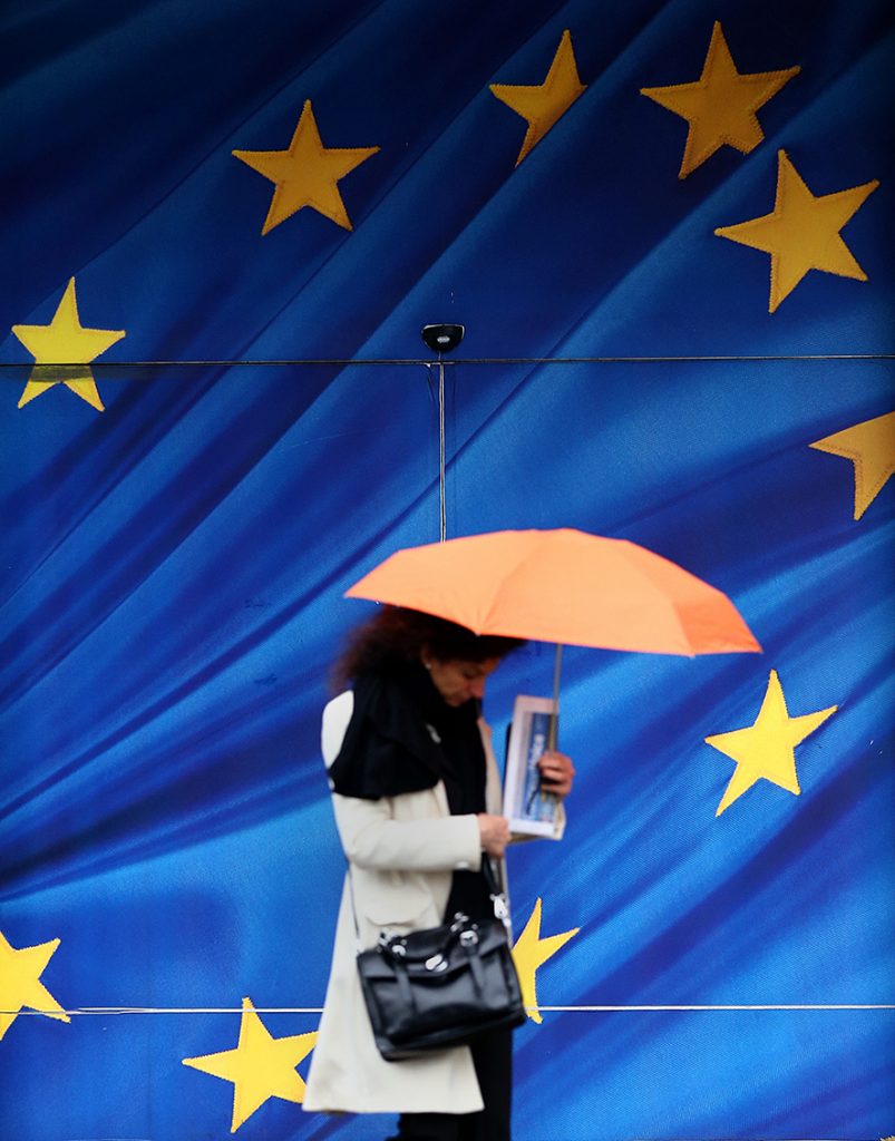 BRUSSELS, BELGIUM - OCTOBER 24: A woman walks past the European Commission building on October 24, 2014 in Brussels, Belgium. Alongside criticism from outgoing European Commission president Jose Manuel Barroso on the UK's stance on EU immigration and a plan to quit the European Court of Human Rights, the UK has now been told to pay an extra £1.7bn GBP (2.1bn EUR) towards the EU's budget because its economy has performed better than expected. (Photo by Carl Court/Getty Images)