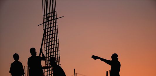 DUBAI, UNITED ARAB EMIRATES - SEPTEMBER 22: Construction workers position steel reinforcement bars on a building site in Al Barsha on September 22, 2015 in Dubai, United Arab Emirates. (Photo by Francois Nel/Getty Images)