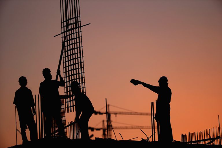 DUBAI, UNITED ARAB EMIRATES - SEPTEMBER 22: Construction workers position steel reinforcement bars on a building site in Al Barsha on September 22, 2015 in Dubai, United Arab Emirates. (Photo by Francois Nel/Getty Images)