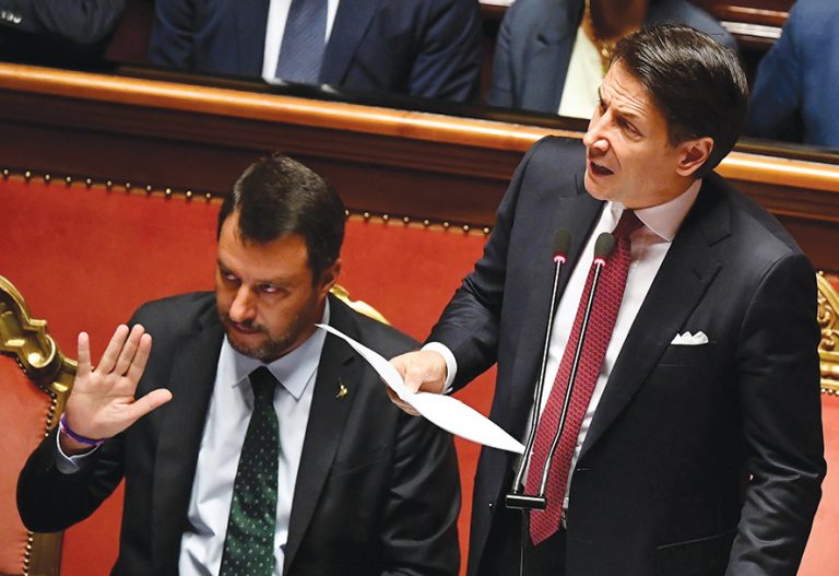 epa07782272 Italian Prime Minister Giuseppe Conte (R) is flanked by Deputy Prime Ministers Matteo Salvini (L) as he addresses the Senate in Rome, Italy, 20 August 2019. Conte in his address to the senate called bringing about the government crisis irresponsible. Deputy Premier and Interior Minister Matteo Salvini and his party League pulled out from government and caused a political crisis a week ago. Conte said that the government has come to an end and that he would resign. EPA/ETTORE FERRARI