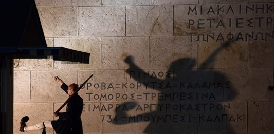 ATHENS, GREECE - JANUARY 21: Greek Presidential Guard soldiers perform their duties in front of the the Greek Tomb of the Unknown Soldier beneath the Hellenic Parliament which is home to the Greek parliament ahead of this weekend general election on January 21, 2015 in Athens, Greece. According to the latest opinion polls, the left-wing Syriza party are poised to defeat Prime Minister Antonis Samaras' conservative New Democracy party in the election, which will take place on Sunday. European leaders fear that Greece could abandon the Euro, write off some of its national debt and put an end to the country's austerity by renogotiating the terms of its bailout if the radical Syriza party comes to power. Greece's potential withdrawal from the eurozone has become known as the 'Grexit'. (Photo by Matt Cardy/Getty Images)