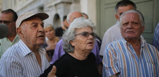 ATHENS, GREECE - JULY 07: Senior citizens talk to bank staff as they queue up to collect their pensions outside a National Bank of Greece branch in Kotzia Square on July 7, 2015 in Athens, Greece. Greek Prime Minister Alexis Tsipras is working on new debt crisis proposals and is due to present them at a Eurozone emergency summit today. (Photo by Christopher Furlong/Getty Images)